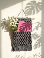 handmade macrame wall pocket organizer with woven cotton texture and boho fringe design